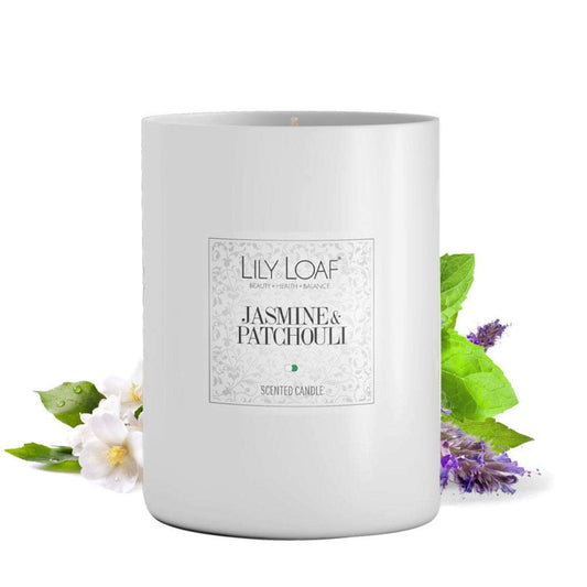 Jasmine & Patchouli Soy Wax Candle with ingredients behind